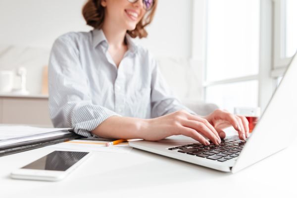 Woman at computer TruCentive Referral Program