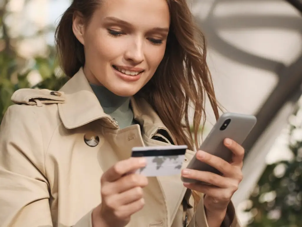 Woman Smiling after adding funds to her debit card