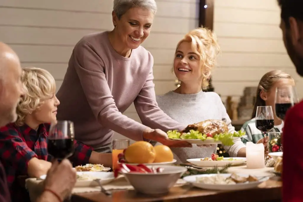 A family enjoying employee thanksgiving dinner provided as part of their companies employee appreciation