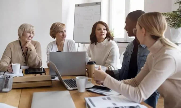 Group of admins sitting around a table planning