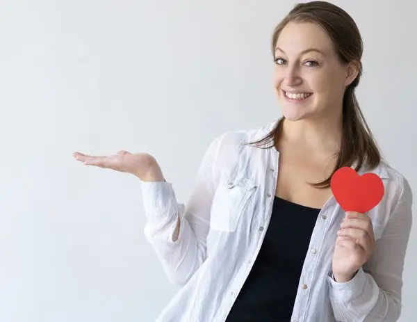 Woman holding a paper heart for world health day