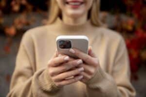 Woman looking at phone after receiving an automated incentive