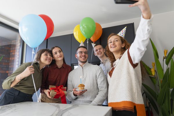 Group of four taking a selfie at a employee birthday party