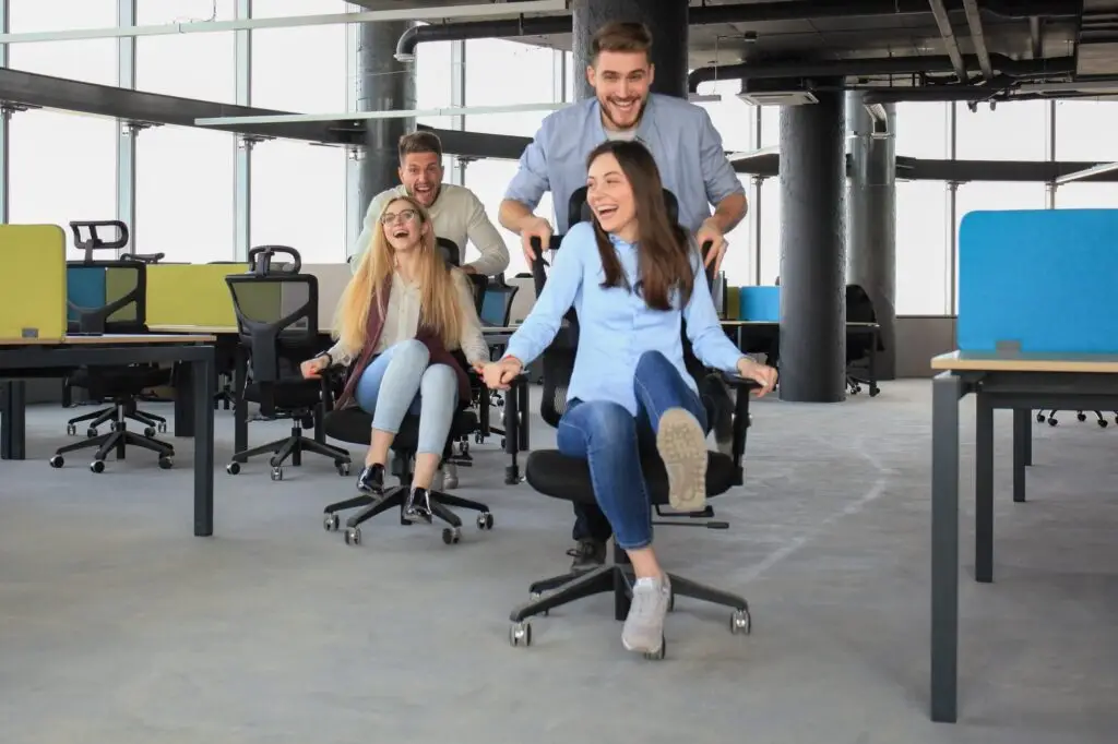 Employees having an office chair race for national fun at work day
