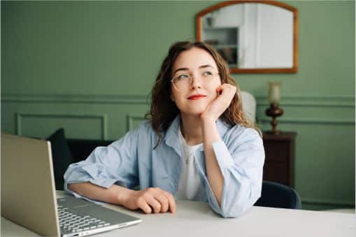 Woman at her computer thinking about who she should reach out to on National Do Something Day