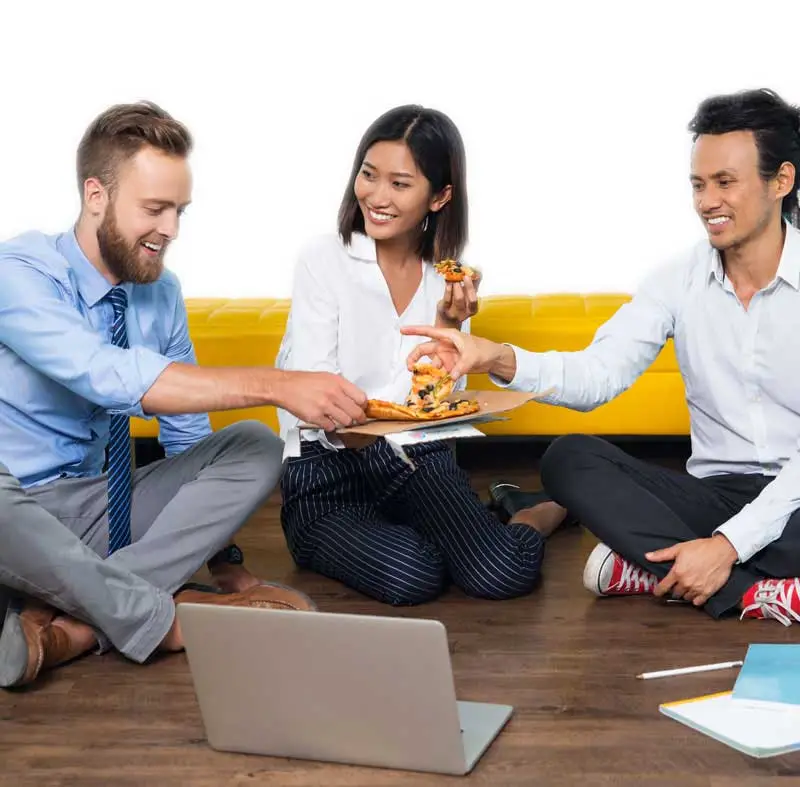 group at work eating pizza