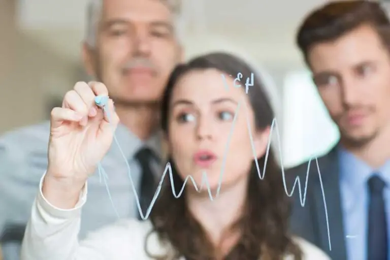 business people drawing a graph on glass
