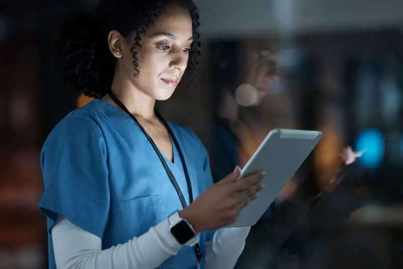 doctor looking at research results on a tablet