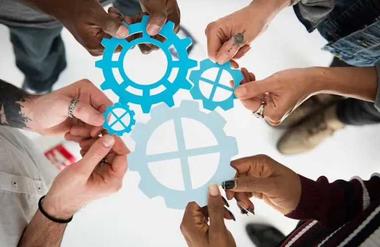 people holding gears as metaphor for system integration