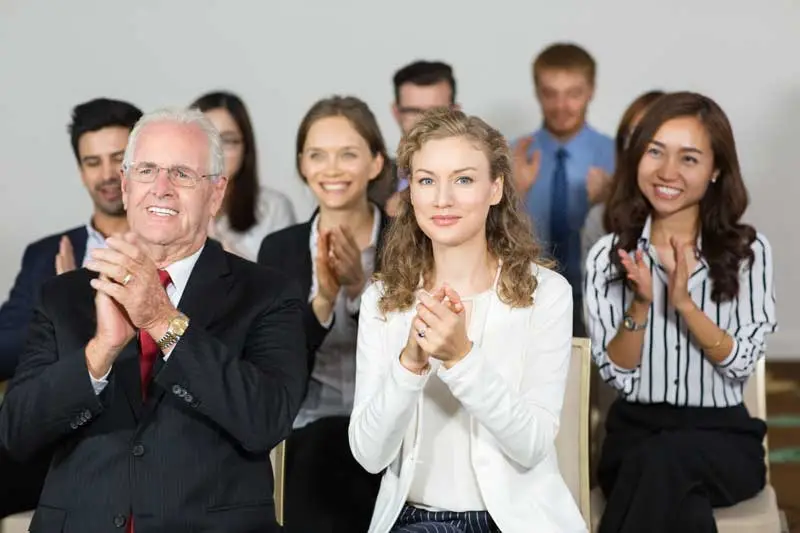 group of business people applauding at recognition event