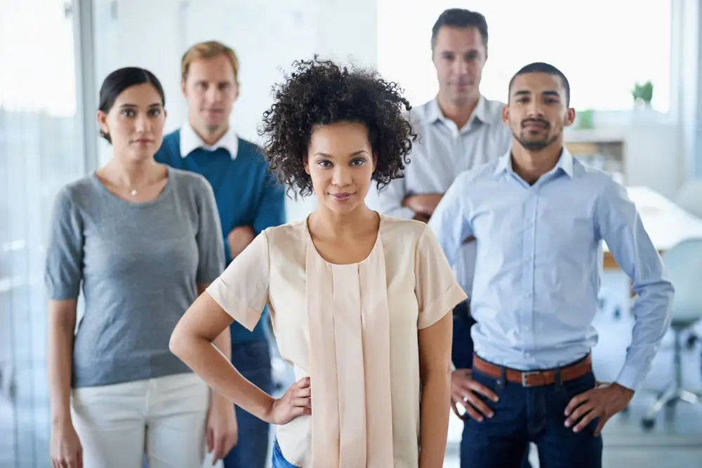 Employee standing wondering if they will stay with their employer in the coming year. Employee gifts go a long way to building loyalty.
