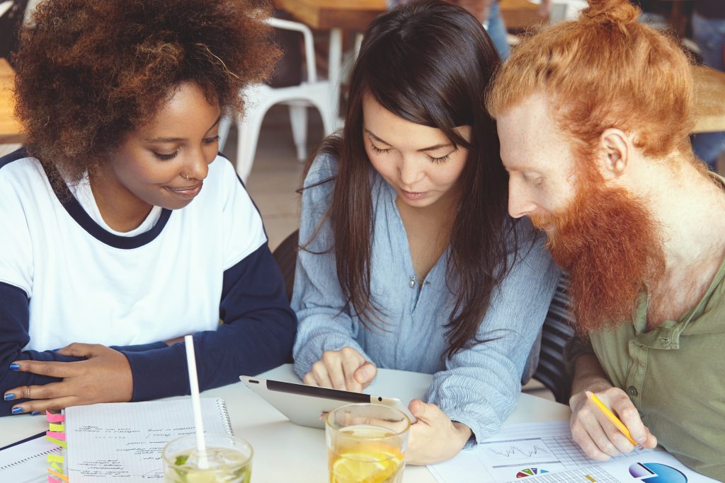 Study participants around a table. They need diverse research compensation options.