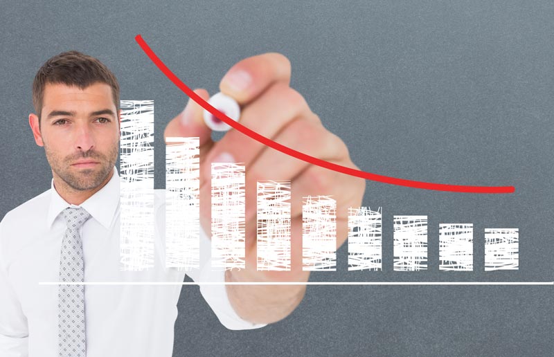 man drawing a declining graph