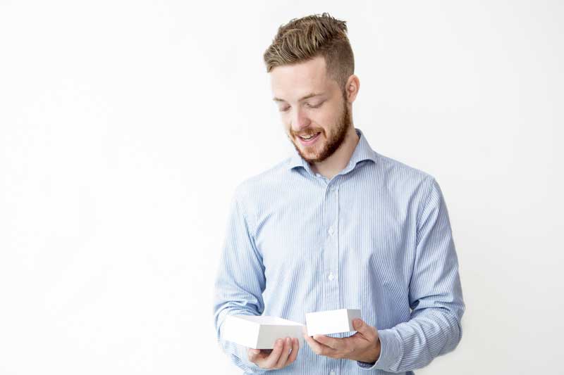 employee smiling at merchandise choice