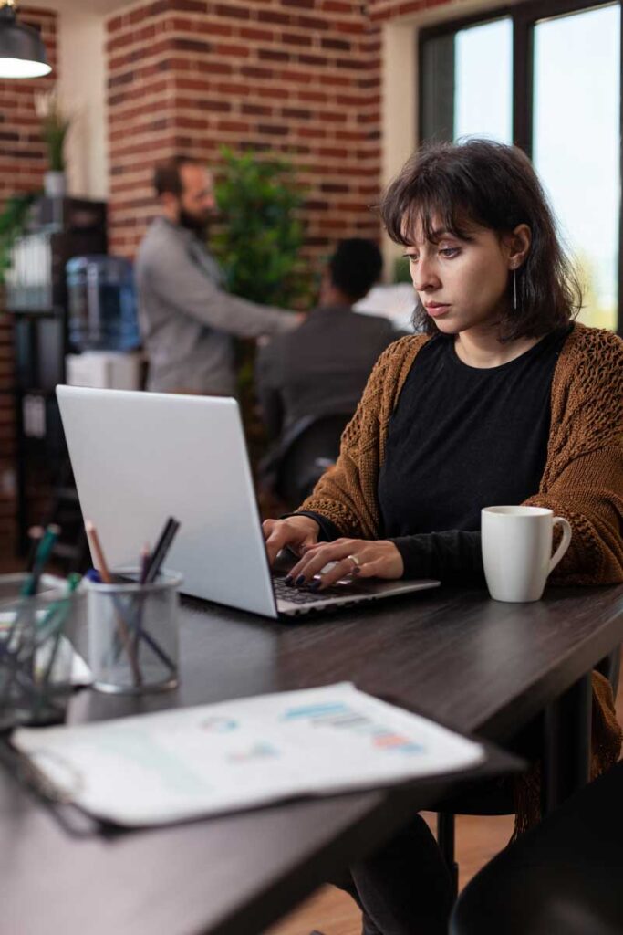 woman running agency programs on laptop