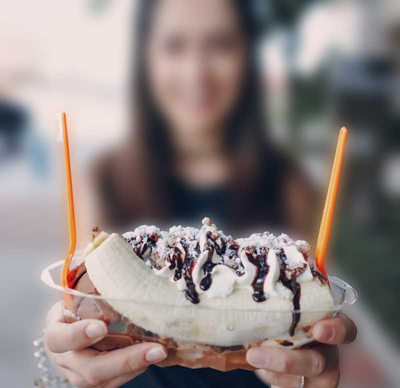 Woman holding a banana split for banana split day