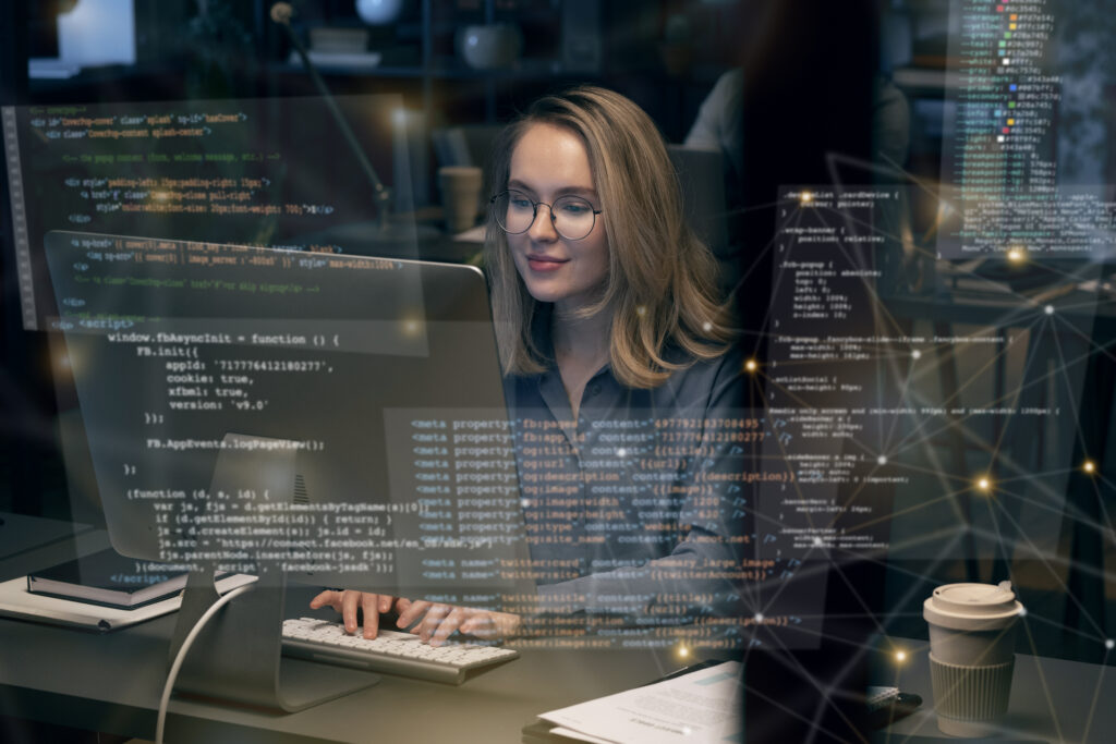 Woman working at her computer with creen overlays in front of her as she works on the TruCentive Gift Card API