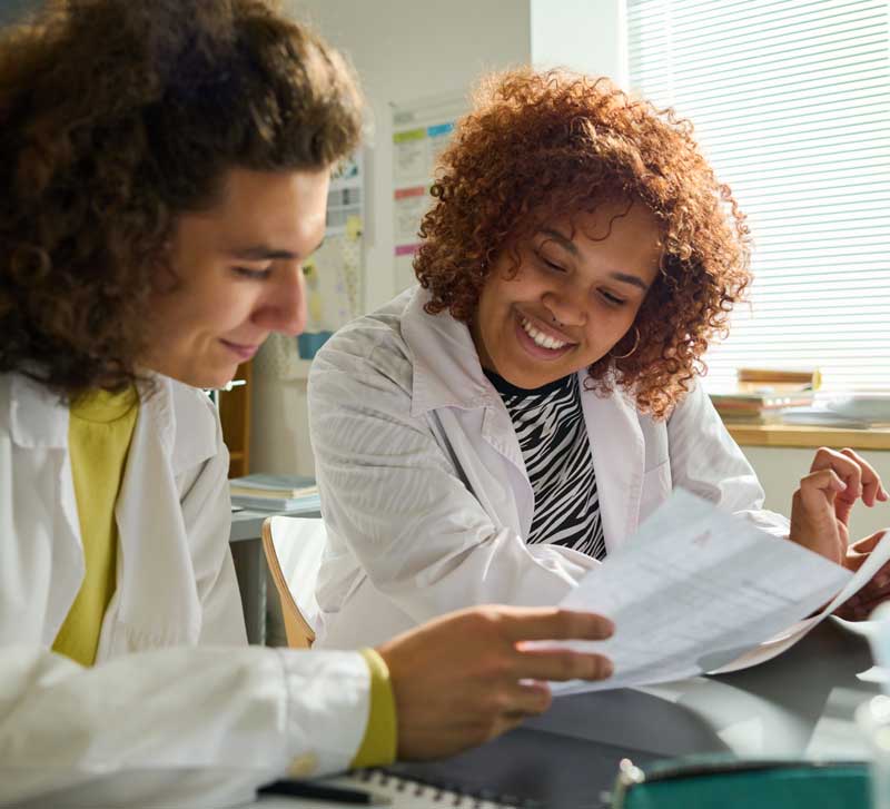 man discussing research trial tasks with researcher