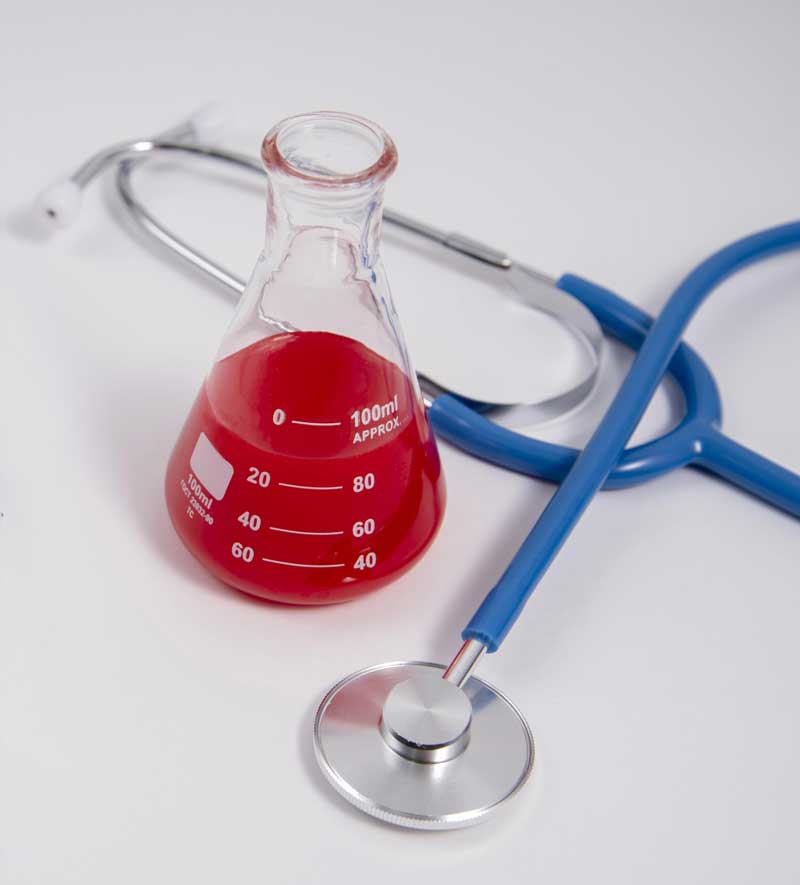 beaker and stethoscope clinical trial day