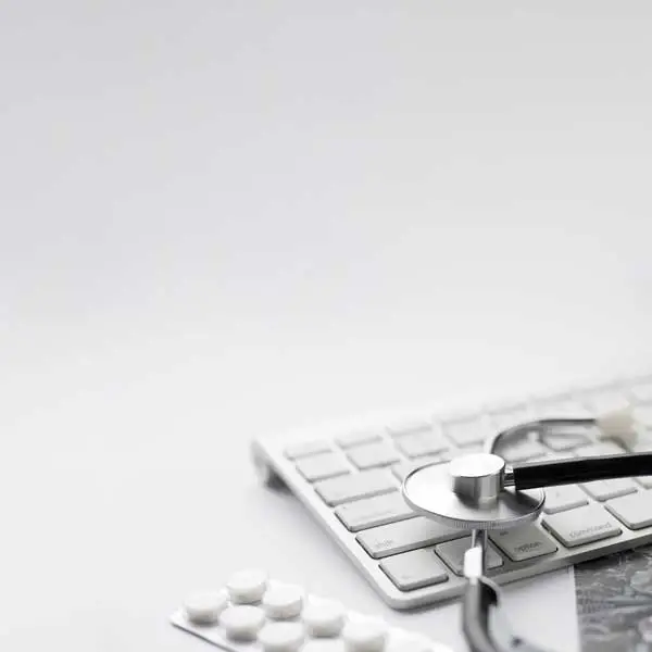 Stethoscope beside a blister pack representing clinical research