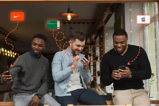 Three men receiving employee gift cards on their phones